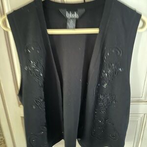 Detailed beaded sweater vest with valour black skirt.